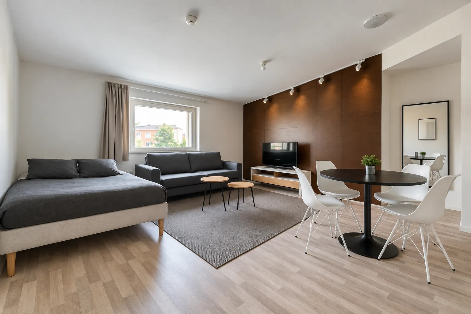 Bed, sofa and small table beside a window