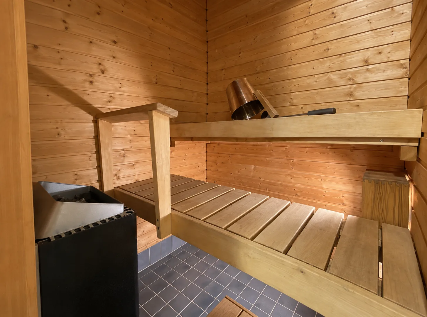 Wooden sauna benches and heater